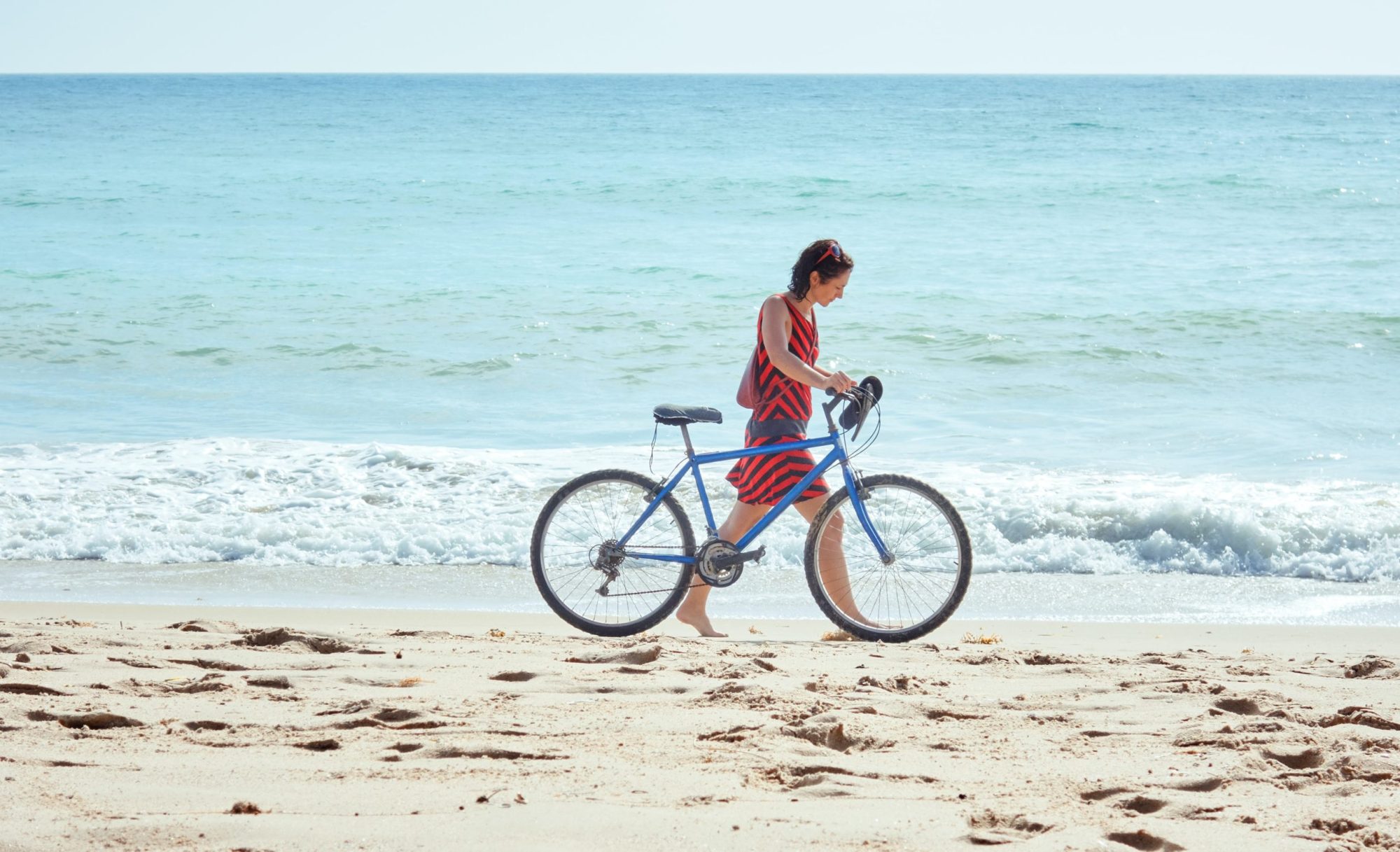 bike (1) a man riding a bicycle on a beach