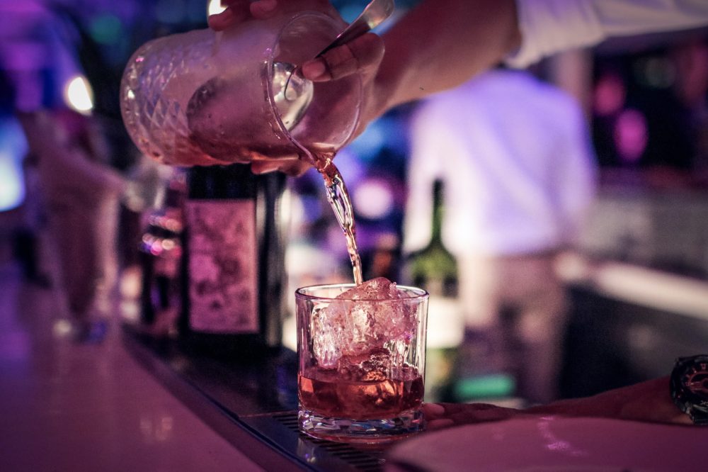 a close up of a person holding a wine glass